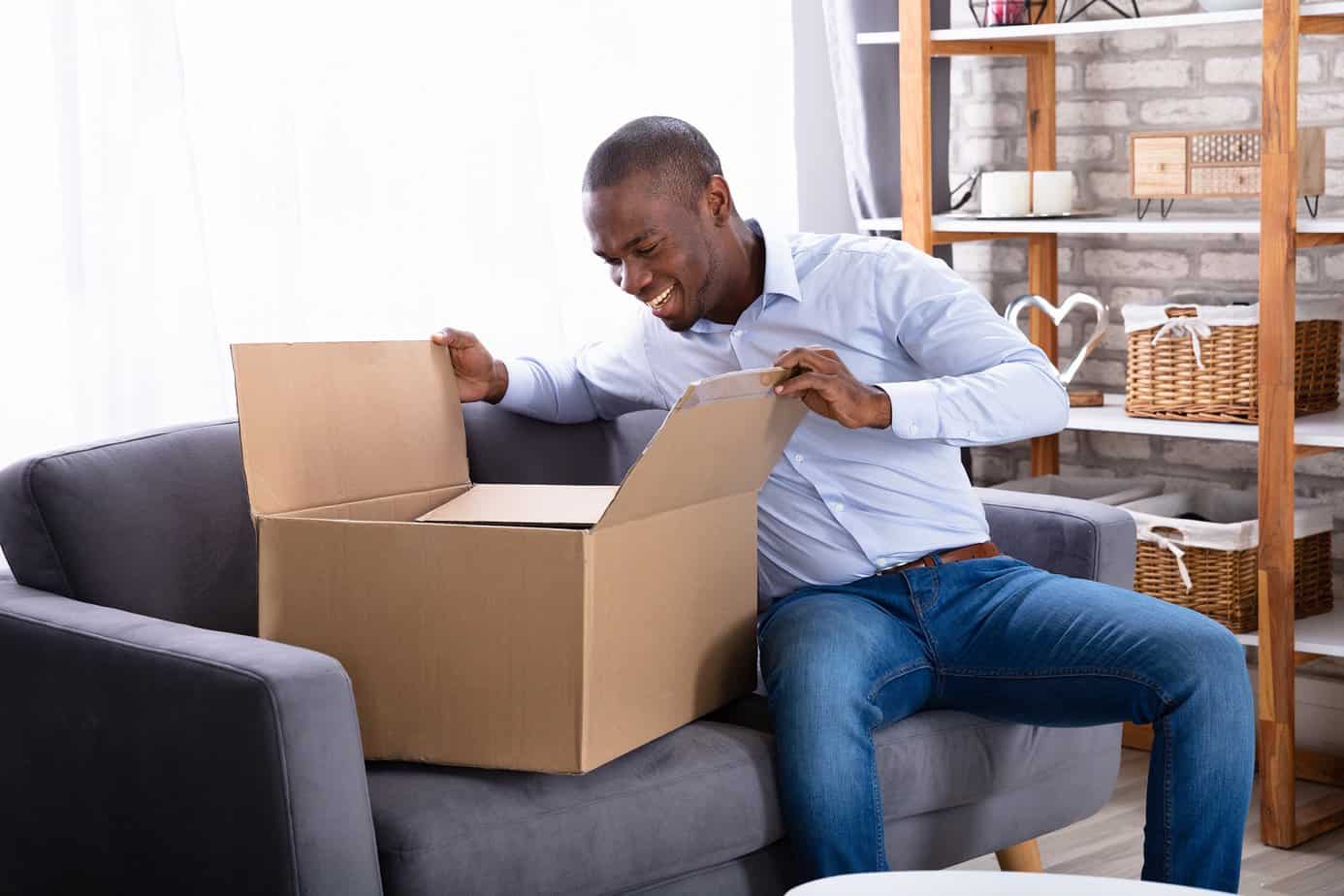 man opening package with an item that will make money