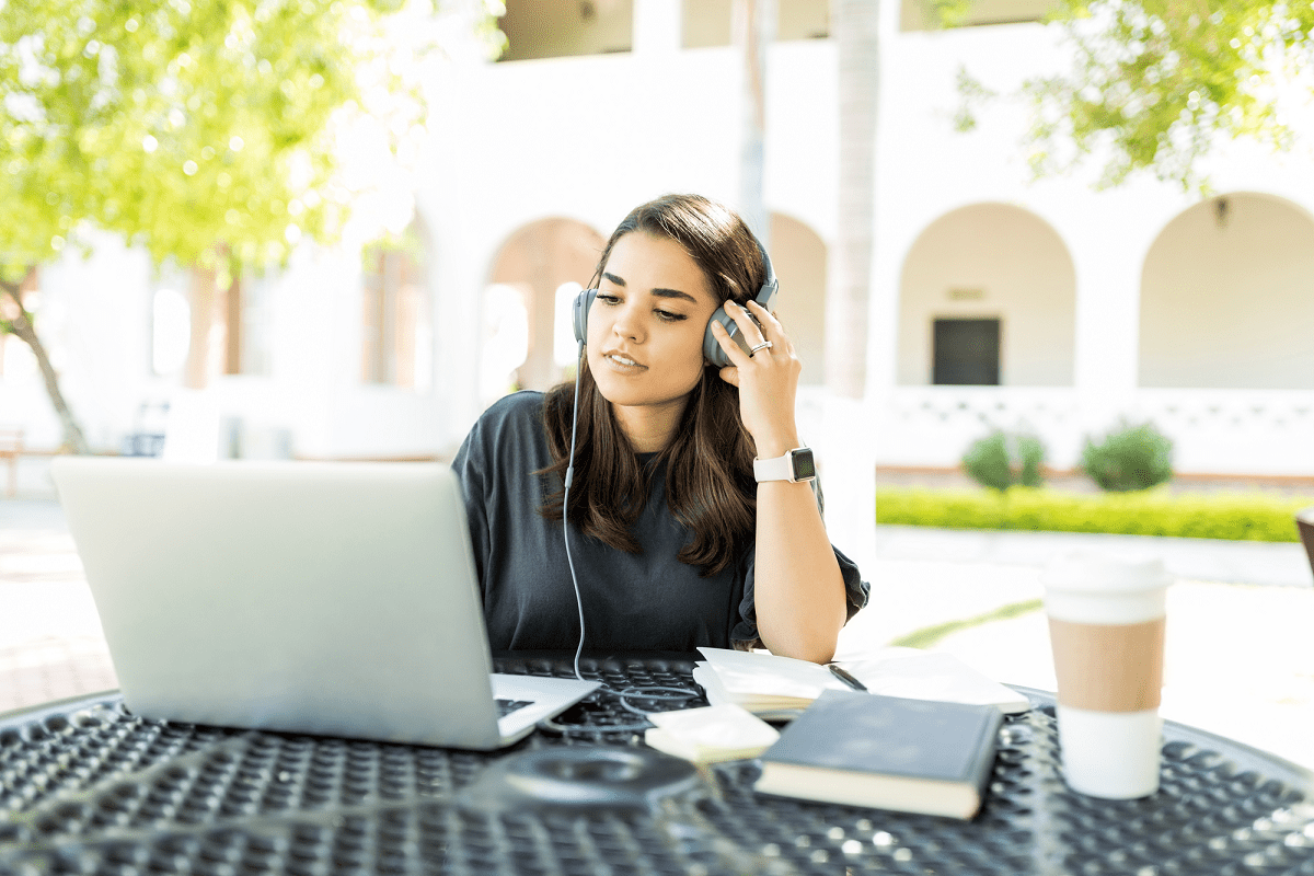 Woman sitting in front of laptop learning how to transcribe audio